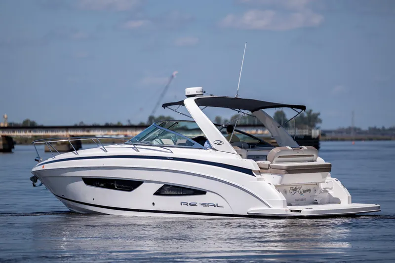 Slide: The Image of 2017 Regal 32 Express boat cruising on calm waters under a clear sky. - 1