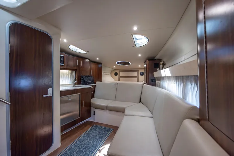 Slide: The Image of Luxurious interior of 2017 Regal 32 Express yacht with modern kitchen and seating area. - 24