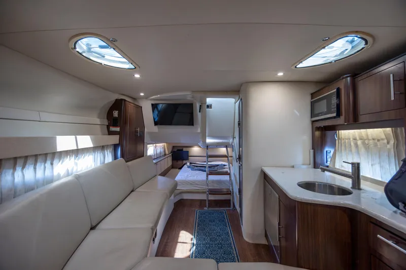 Slide: The Image of Interior of 2017 Regal 32 Express yacht with modern kitchen and cozy seating area. - 22