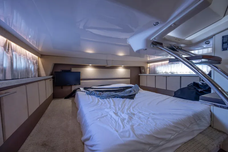 Slide: The Image of Luxurious interior cabin of a 2017 Regal 32 Express yacht with bed and TV. - 13