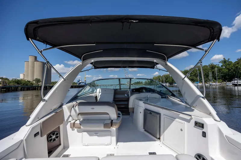 Slide: The Image of 2017 Regal 32 Express boat interior with canopy, docked on a sunny day. - 8