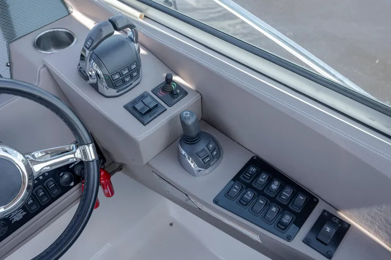 Slide: The Image of Control panel of a 2017 Regal 32 Express boat with steering wheel and switches. - 10