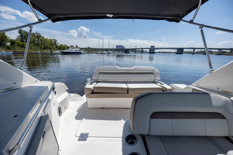 Slide: The Image of 2017 Regal 32 Express boat interior with seating, overlooking a serene waterfront view. - 15