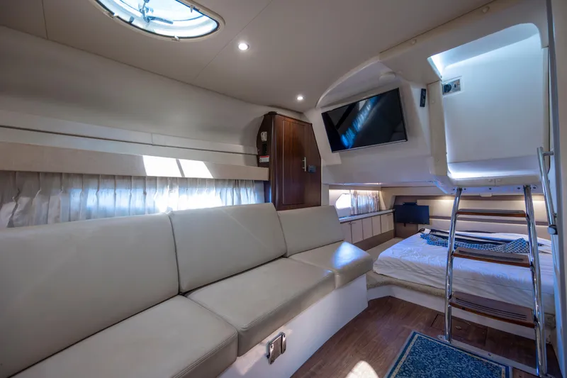 Slide: The Image of Luxurious interior of a 2017 Regal 32 Express yacht with sofa, bed, and TV. - 21