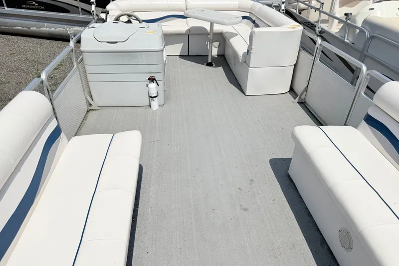 Slide: The Image of 2001 Harris Cruiser 220 pontoon boat interior with white seating and steering console. - 7