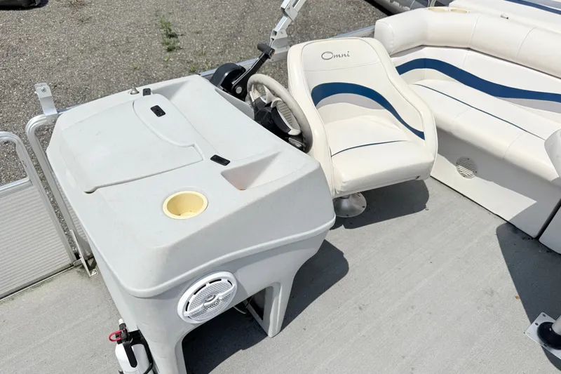 Slide: The Image of 2001 Harris Cruiser 220 boat interior with white seating and storage compartment. - 8
