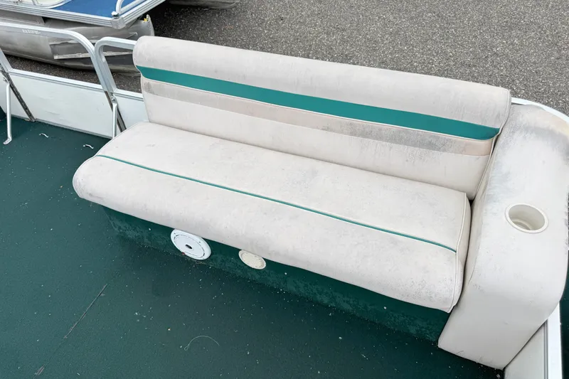 Slide: The Image of 1999 Sweetwater Challenger 220 ES boat seat with teal accents and cup holder. - 5