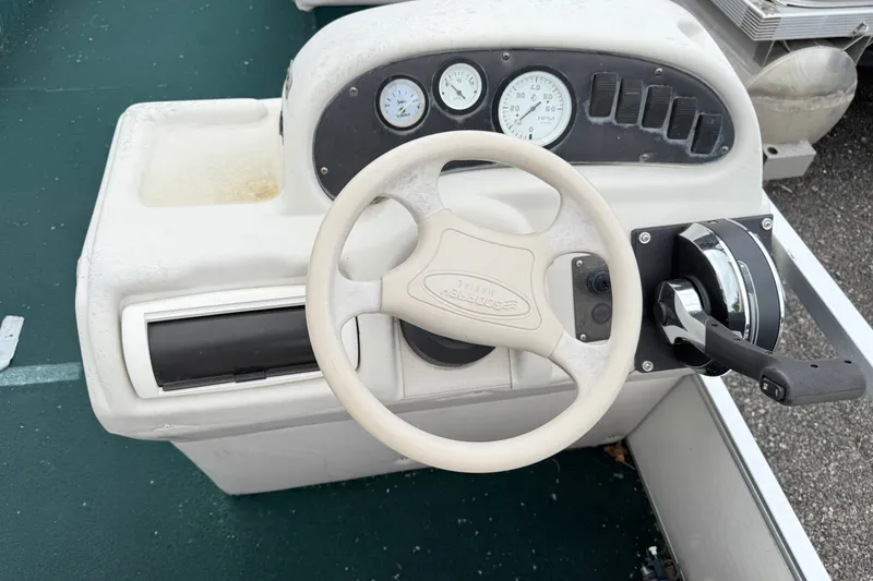 Slide: The Image of Steering console of a 1999 Sweetwater Challenger 220 ES boat with gauges and controls. - 9