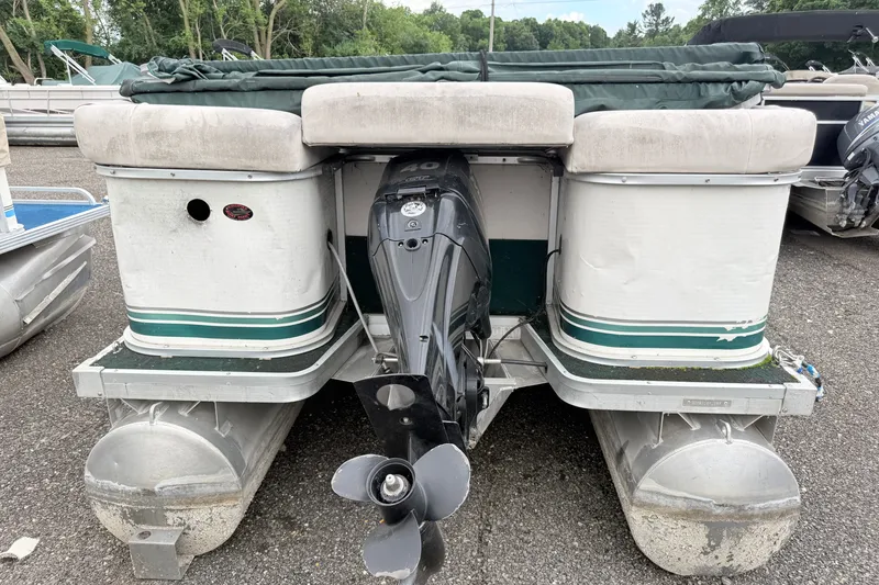 Slide: The Image of 1999 Sweetwater Challenger 220 ES pontoon boat with outboard motor, parked on gravel. - 3