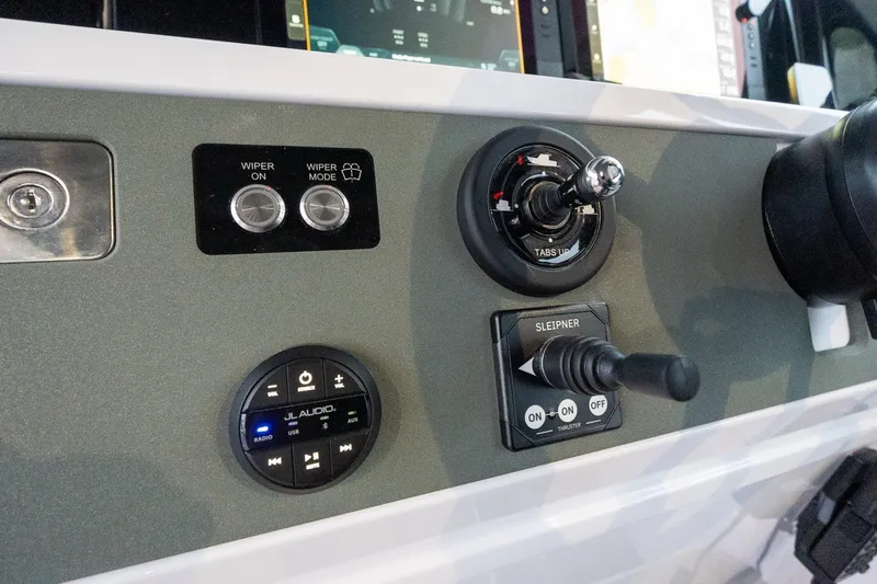 Slide: The Image of Control panel of 2026 Axopar 38 Cross Cabin with wiper and audio controls. - 39