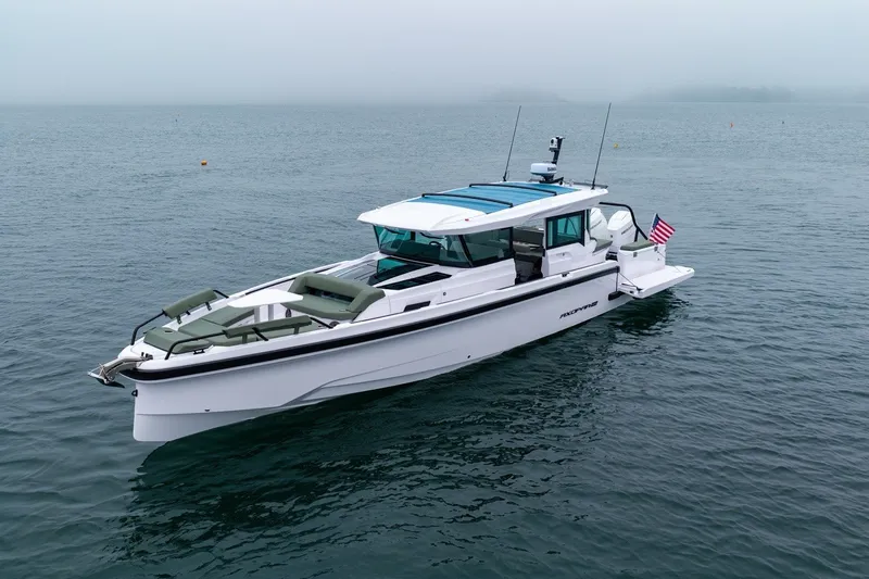 Slide: The Image of 2026 Axopar 38 Cross Cabin boat on calm water, featuring sleek design and modern amenities. - 3