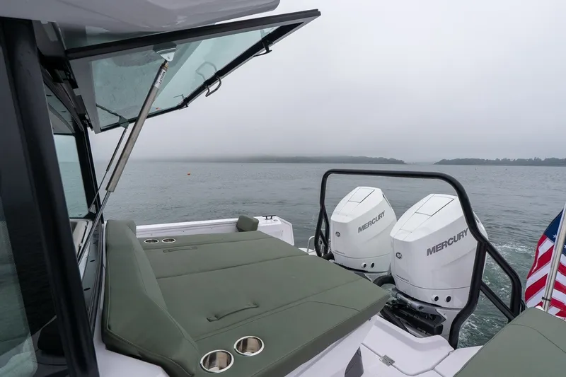 Slide: The Image of 2026 Axopar 38 Cross Cabin with Mercury engines on a misty lake. - 18
