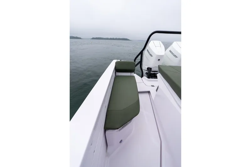 Slide: The Image of 2026 Axopar 38 Cross Cabin boat with green seating and Mercury engines on a calm sea. - 23