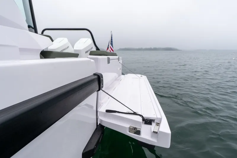 Slide: The Image of 2026 Axopar 38 Cross Cabin boat with open side platform on calm water. - 22