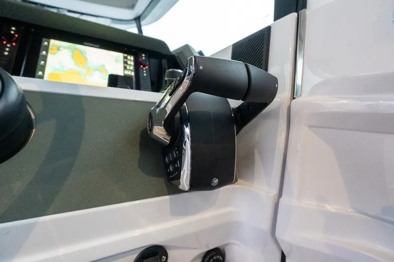 Slide: The Image of 2026 Axopar 38 Cross Cabin throttle control and navigation display. - 38