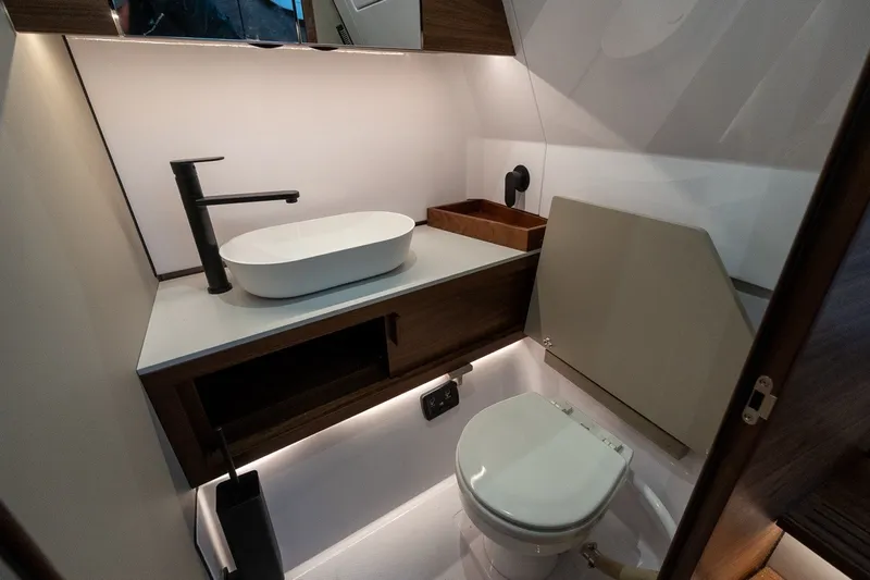 Slide: The Image of Modern bathroom in 2026 Axopar 38 Cross Cabin boat, featuring sleek sink and toilet. - 53