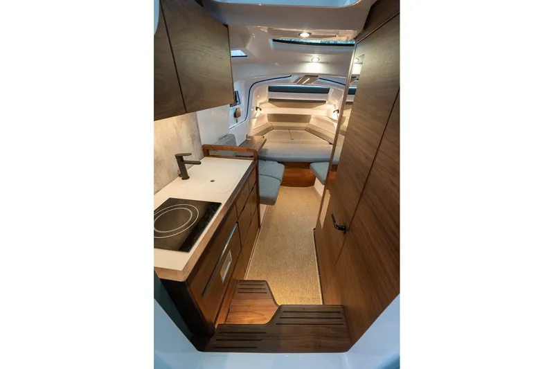 Slide: The Image of 2026 Axopar 38 Cross Cabin interior with modern kitchen and cozy seating area. - 44
