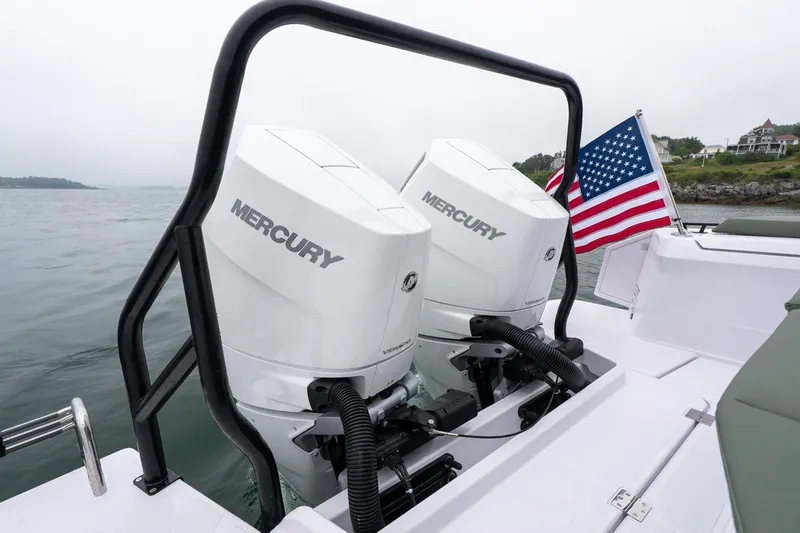 Slide: The Image of Twin Mercury outboard engines on 2026 Axopar 38 Cross Cabin boat with American flag. - 21