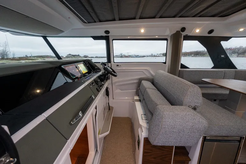 Slide: The Image of Interior of 2026 Axopar 38 Cross Cabin with modern helm and seating area. - 25