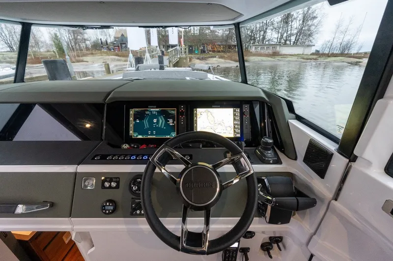Slide: The Image of Interior view of 2026 Axopar 38 Cross Cabin boat cockpit with navigation screens. - 35