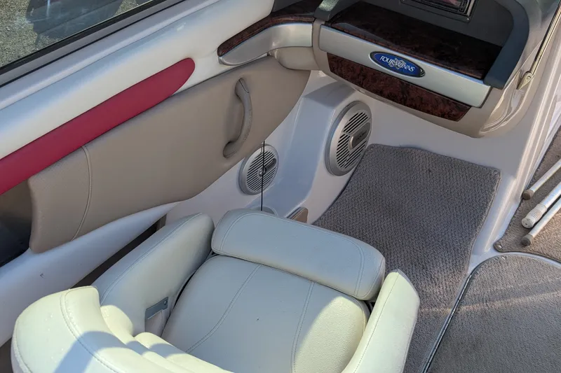 Slide: The Image of Interior of a 2006 Four Winns 210 Horizon boat, featuring seating and speaker system. - 7