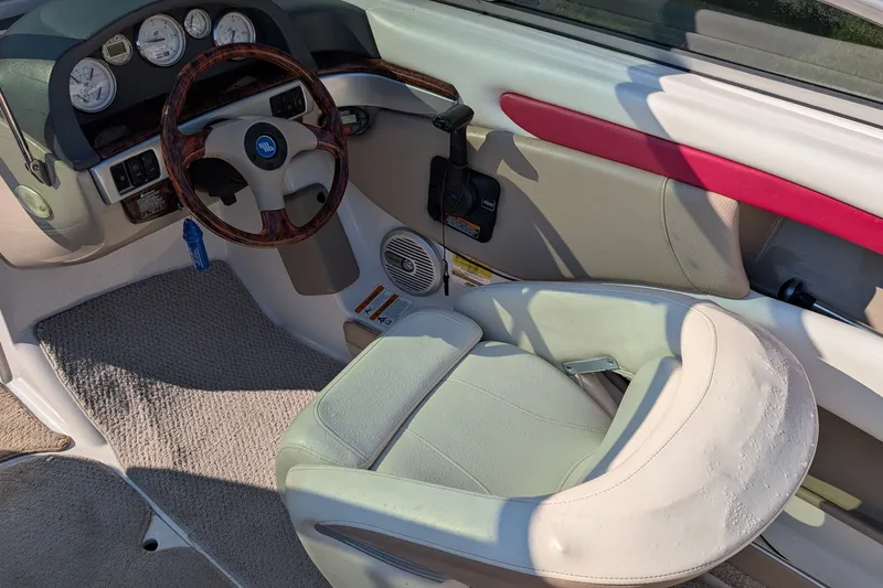 Slide: The Image of Interior of a 2006 Four Winns 210 Horizon boat, featuring steering wheel and dashboard. - 6