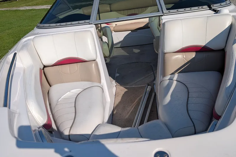 Slide: The Image of Interior of a 2006 Four Winns 210 Horizon boat with white and beige seating. - 15