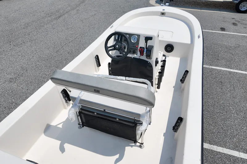 Slide: The Image of 2027 Carolina Skiff E18 JVX CC boat interior with steering console and seating. - 5