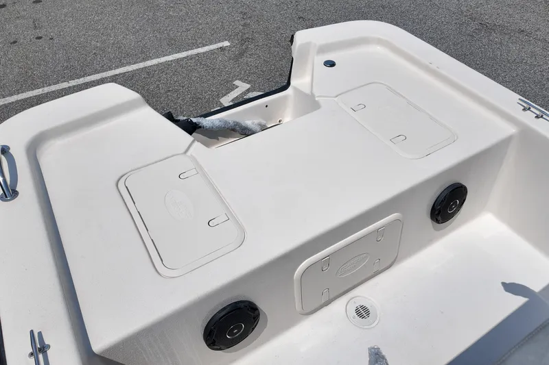 Slide: The Image of 2027 Carolina Skiff E18 JVX CC boat deck with storage compartments and speakers. - 10