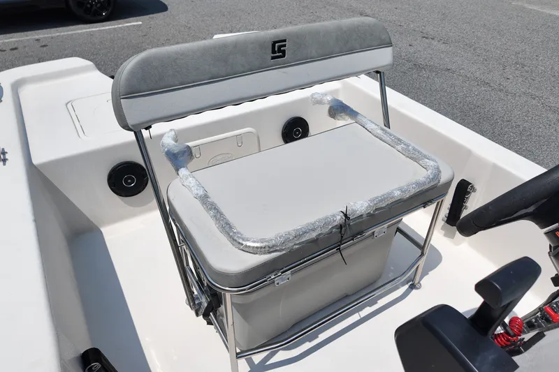 Slide: The Image of 2027 Carolina Skiff E18 JVX CC boat interior with cushioned seating and steering console. - 8