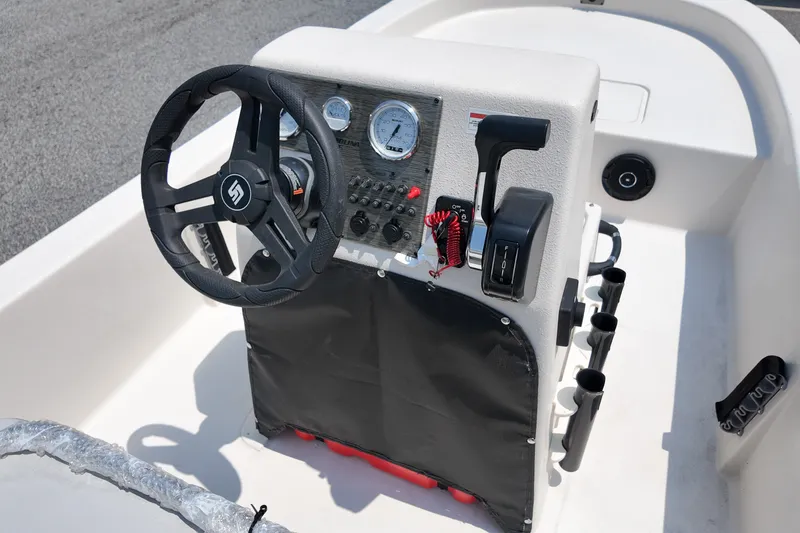 Slide: The Image of 2027 Carolina Skiff E18 JVX CC boat console with steering wheel and controls. - 9