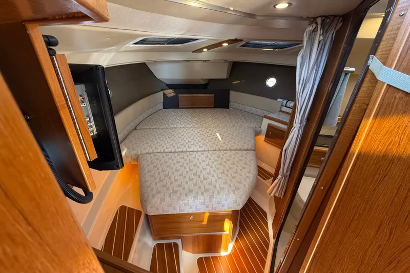 Slide: The Image of Interior of 2023 Ranger Tugs R-29 S, featuring cozy cabin with wood accents and comfortable seating. - 7