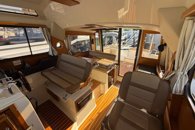 Slide: The Image of Interior of 2023 Ranger Tugs R-29 S boat with seating and wood accents. - 5