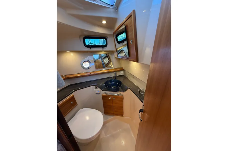 Slide: The Image of 2023 Ranger Tugs R-29 S boat bathroom with modern fixtures and wood accents. - 8