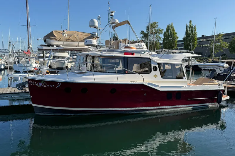 The Image of 2023 Ranger Tugs R-29 S boat docked in a marina under clear blue skies. - 0