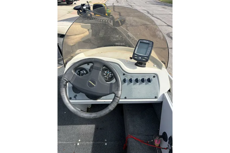 Slide: The Image of 1998 Alumacraft boat dashboard with steering wheel and fish finder. - 3