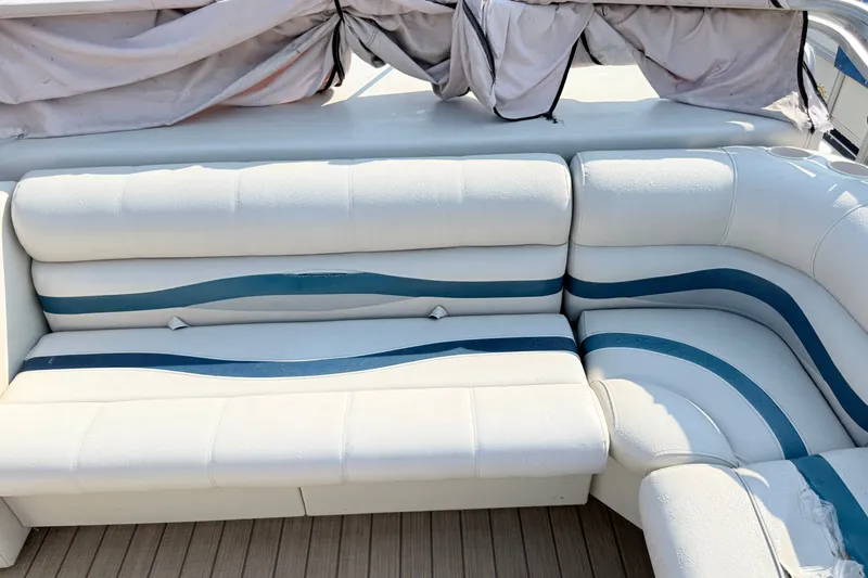 Slide: The Image of White and blue seating on a 1999 Crest 240 boat, featuring a curved design. - 8