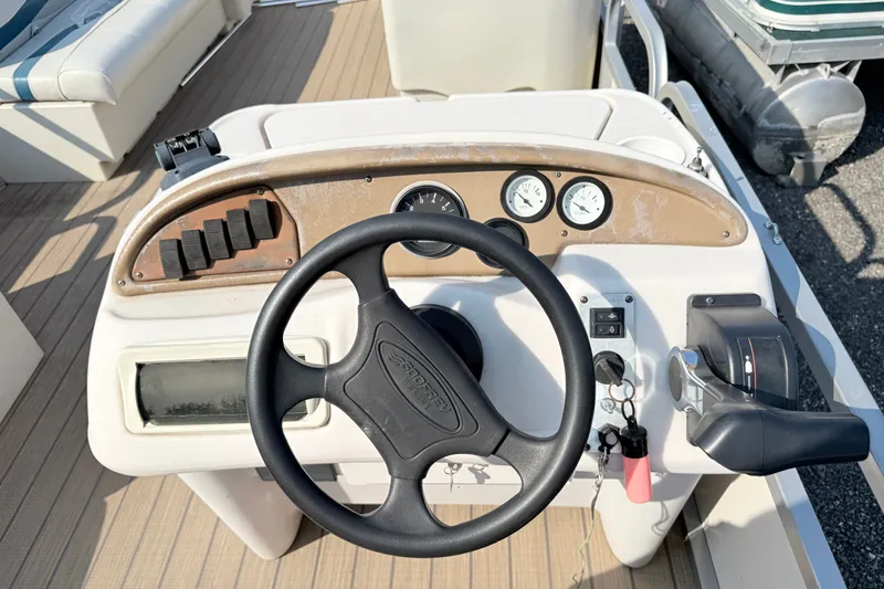 Slide: The Image of Steering console of a 1999 Crest 240 boat with gauges and controls. - 10