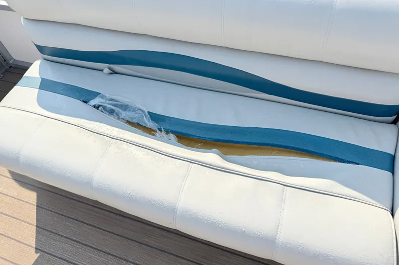 Slide: The Image of Damaged white and blue boat seat on a 1999 Crest 240. - 5