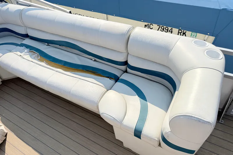 Slide: The Image of White and blue seating on a 1999 Crest 240 boat, showing wear and tear. - 7