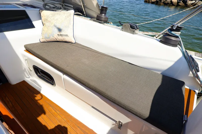 Slide: The Image of Cushioned seating area on 2016 Hanse 385 sailboat deck, with nautical-themed pillow. - 55