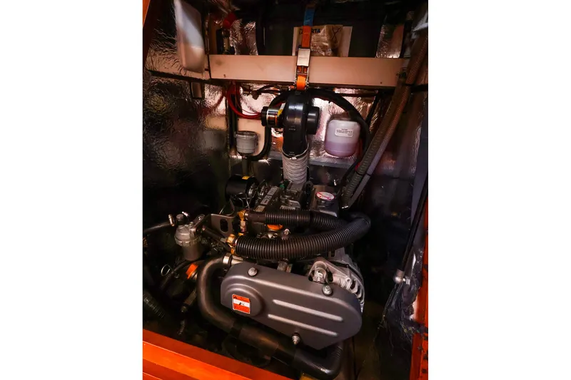 Slide: The Image of Engine compartment of a 2016 Hanse 385 yacht, showcasing mechanical components and wiring. - 48
