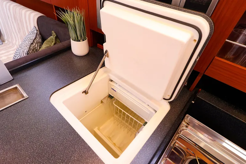 Slide: The Image of Open refrigerator in the galley of a 2016 Hanse 385 yacht interior. - 30