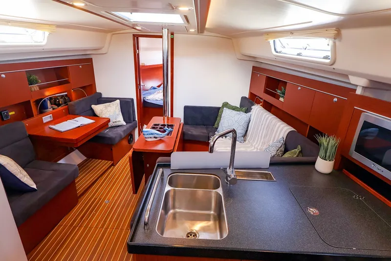 Slide: The Image of Interior of 2016 Hanse 385 yacht with modern kitchen and cozy seating area. - 24