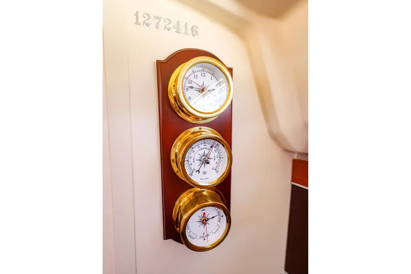 Slide: The Image of Brass nautical instruments on Hanse 385 yacht, 2016 model, displaying time, barometer, and hygrometer. - 42