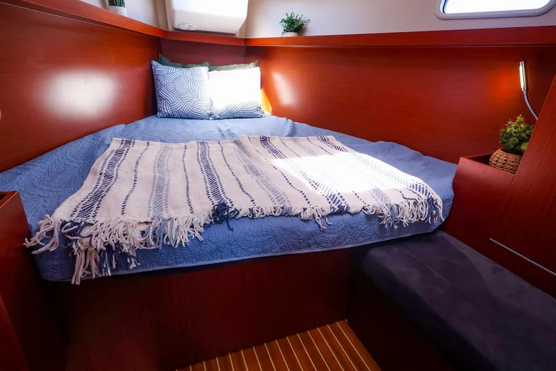 Slide: The Image of Cozy cabin interior of 2016 Hanse 385 yacht with blue bedding and wooden accents. - 46