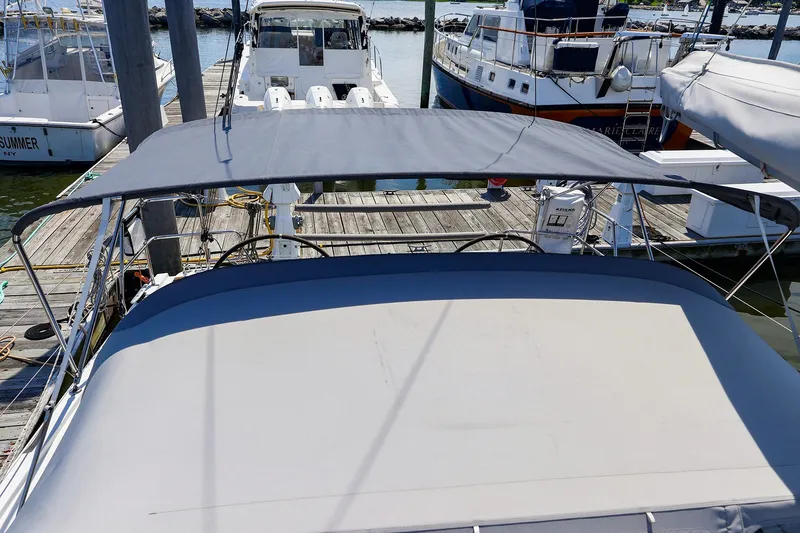 Slide: The Image of 2016 Hanse 385 yacht docked at marina with sunshade canopy. - 16
