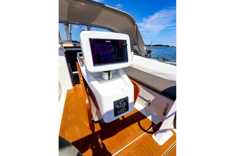 Slide: The Image of Cockpit of 2016 Hanse 385 sailboat with navigation equipment and wooden flooring. - 56