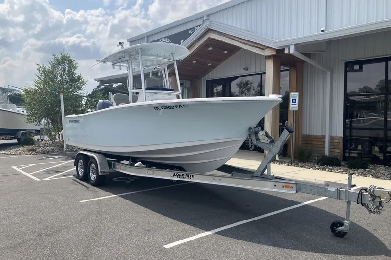 Slide: The Image of 2023 Sportsman Open 232 Center Console boat on trailer outside a building. - 4