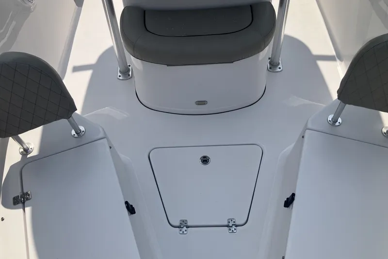 Slide: The Image of 2023 Sportsman Open 232 Center Console boat interior with seating and storage compartments. - 17